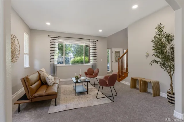 a living room with furniture and a large window