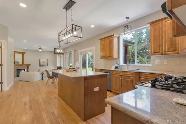 a open kitchen with stainless steel appliances granite countertop a sink stove and refrigerator