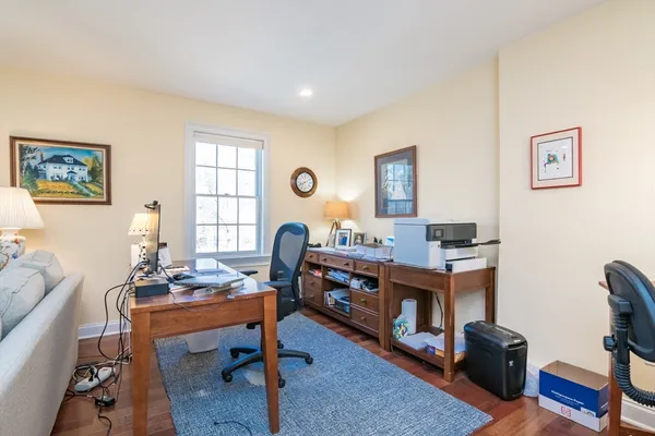 a view of a workspace with lounge chair and a window