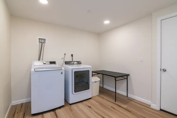 a utility room with sink dryer and washer