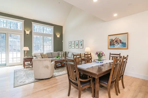 a view of a dining room with furniture and a large window