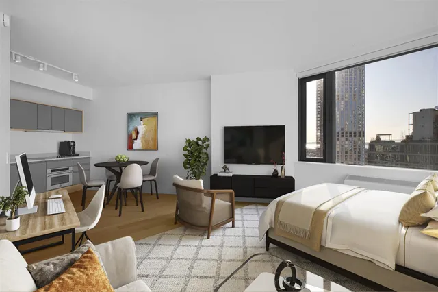 a bedroom with a bed a large window and a couch