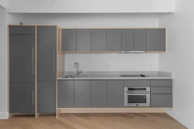 a kitchen with stainless steel appliances granite countertop a refrigerator and a stove