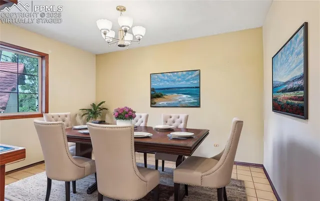 a view of a dining room with furniture and a chandelier