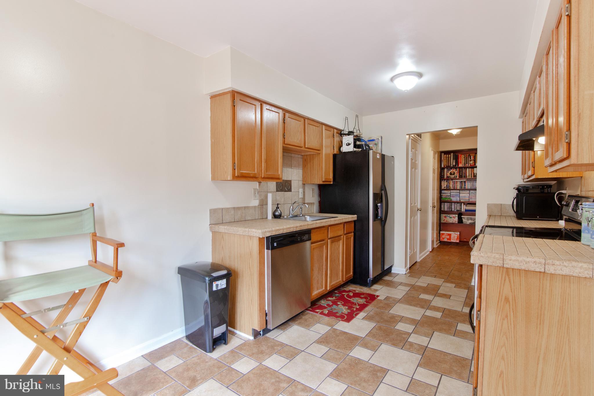 9304 Palmer Place, Unit 5 Laurel, MD 20708 - Photo 14 of 30 a kitchen with a refrigerator and a sink