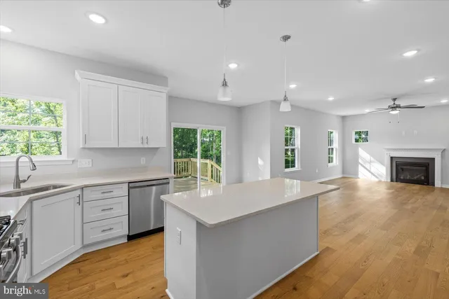 a kitchen with white cabinets a stove and a sink