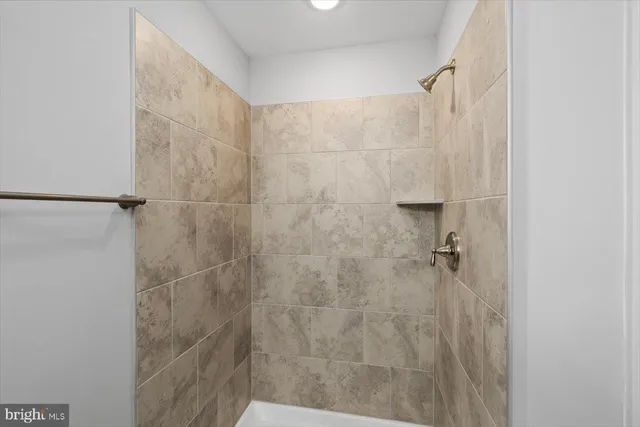 a bathroom with a double vanity sink mirror and shower