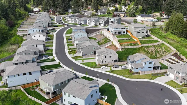 an aerial view of a swimming pool with outdoor seating