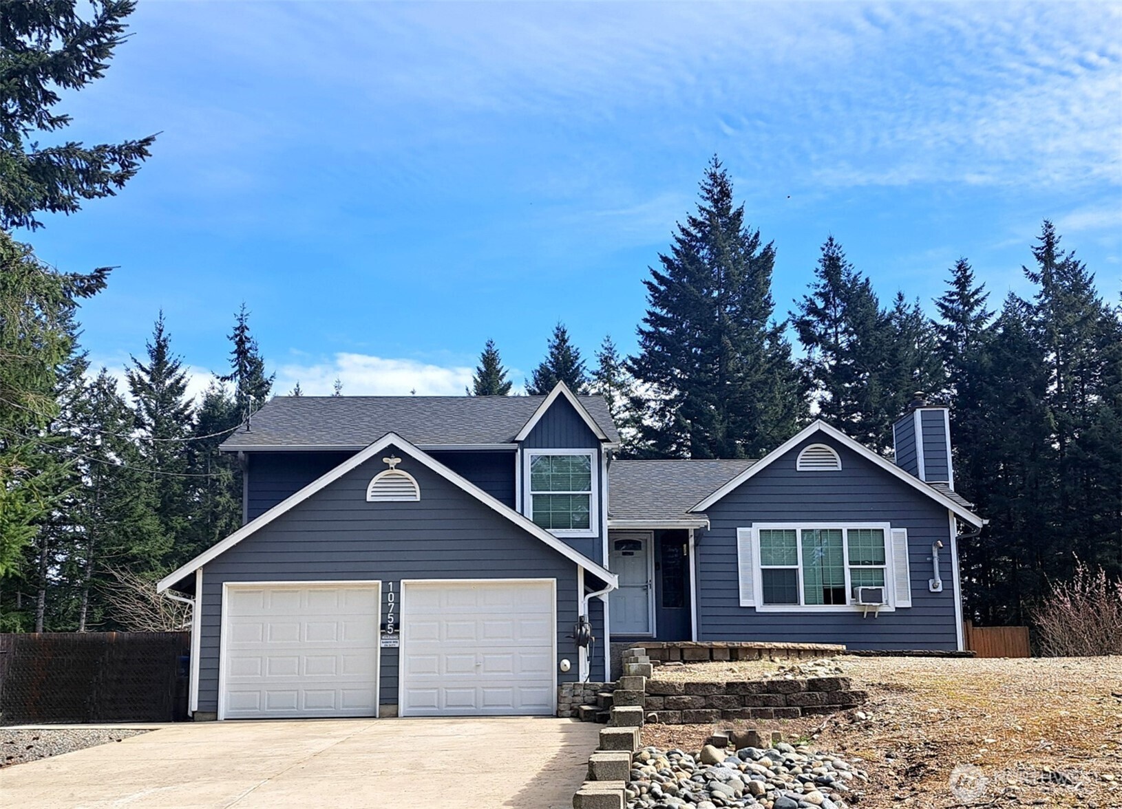 10755 Ridge Rim Trail Southeast Port Orchard, WA 98367 - Photo 1 of 2 a front view of a house with a yard and trees