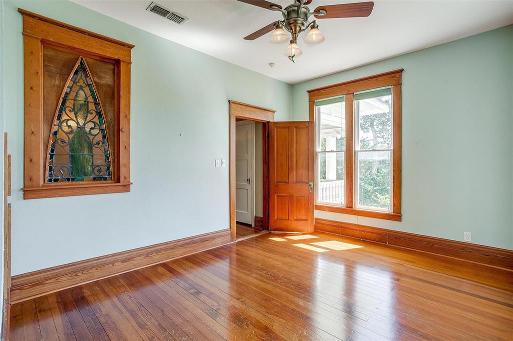 708 South Waco Street Weatherford, TX 76086 - Photo 11 of 35 a view of an empty room with a window and wooden floor