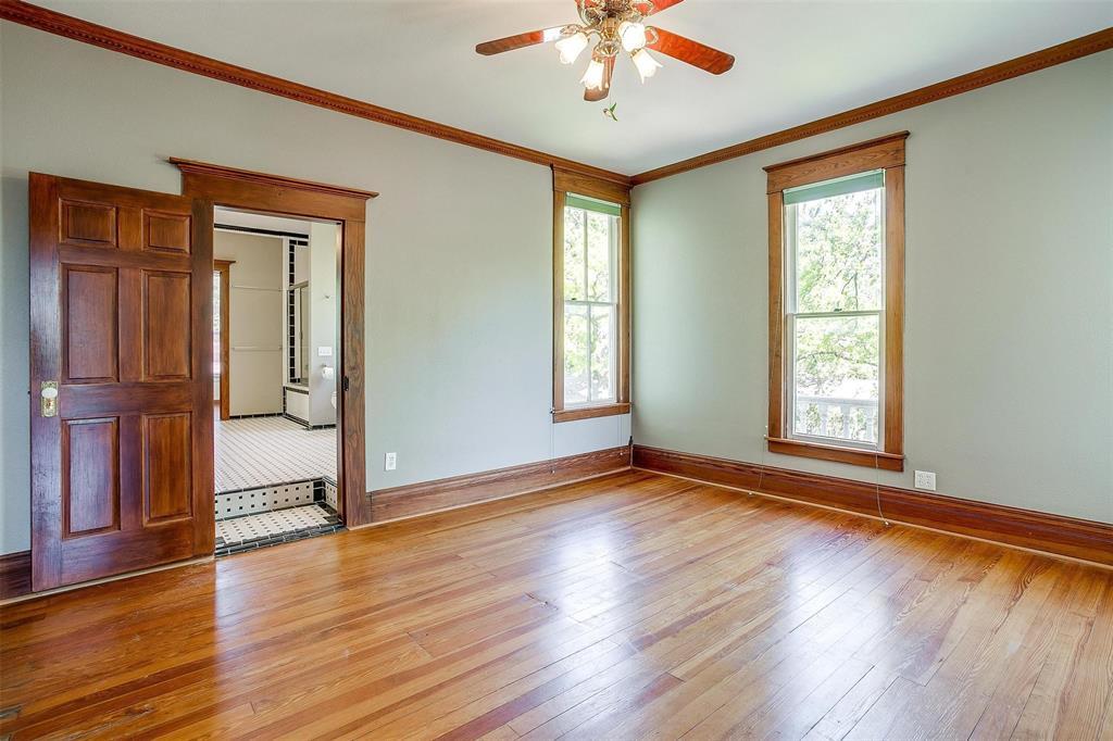 708 South Waco Street Weatherford, TX 76086 - Photo 16 of 35 a view of an empty room with wooden floor and a window