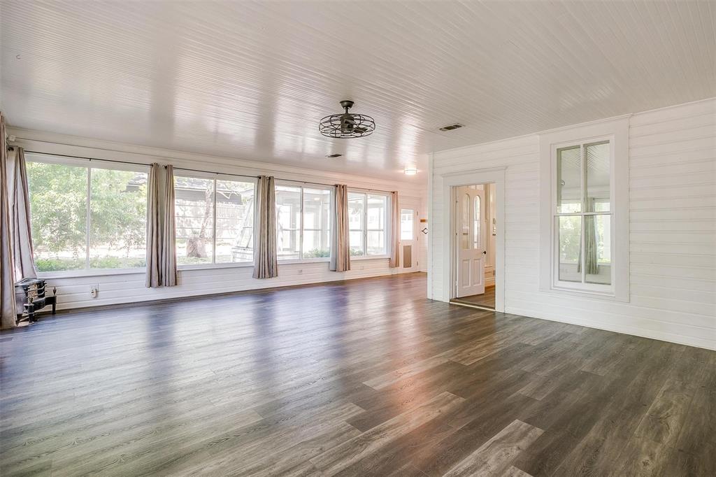 708 South Waco Street Weatherford, TX 76086 - Photo 18 of 35 a view of an empty room with wooden floor and a window