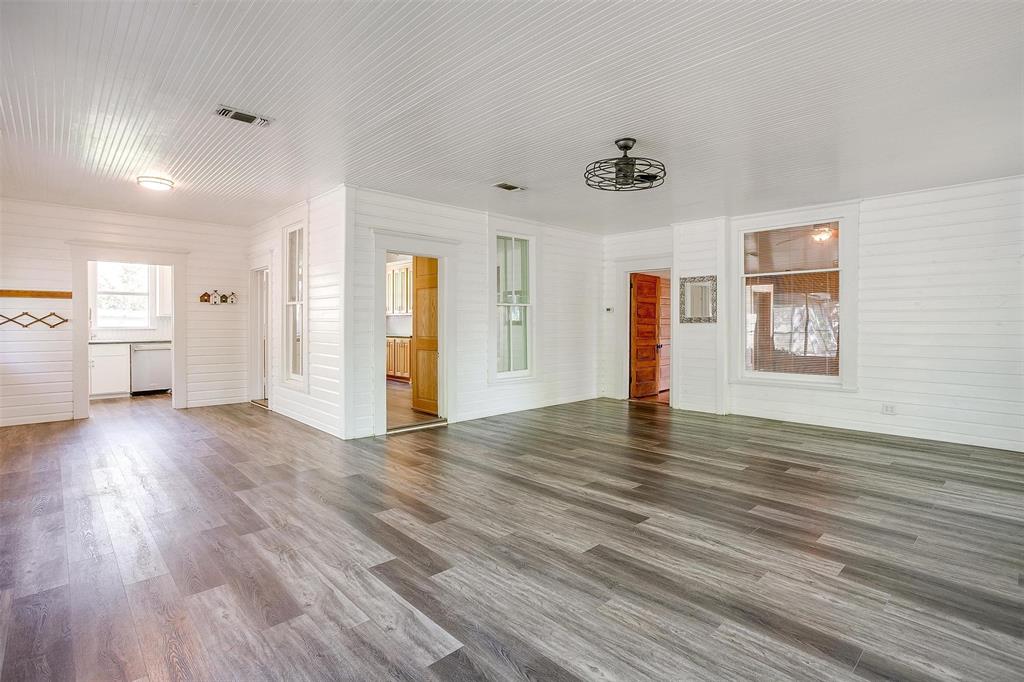 708 South Waco Street Weatherford, TX 76086 - Photo 19 of 35 a view of empty room with wooden floor and window