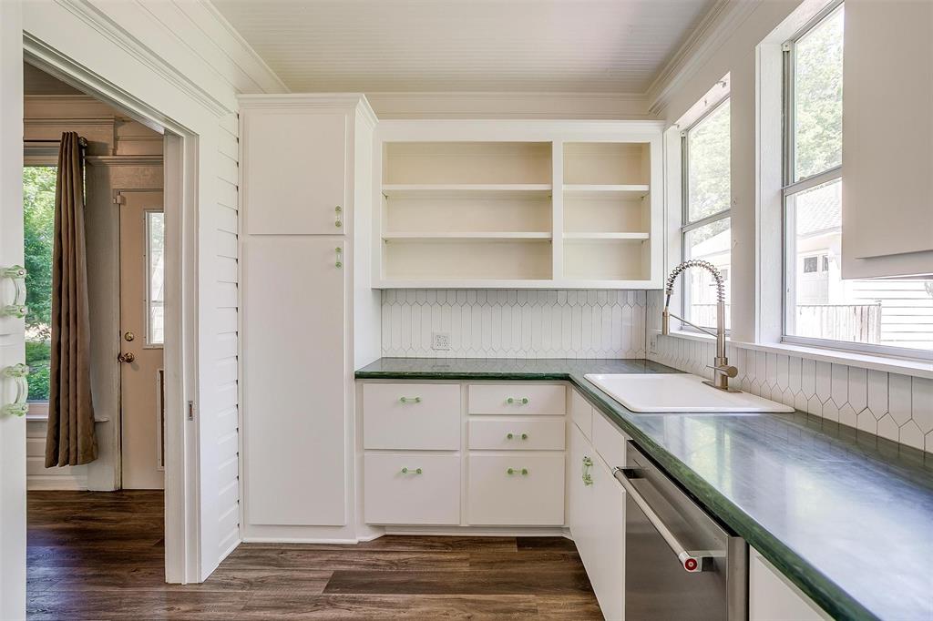 708 South Waco Street Weatherford, TX 76086 - Photo 21 of 35 a view of a kitchen counter space with wooden floor and cabinet