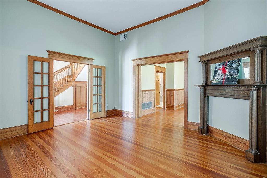 708 South Waco Street Weatherford, TX 76086 - Photo 26 of 35 a view of an empty room with wooden floor and a window