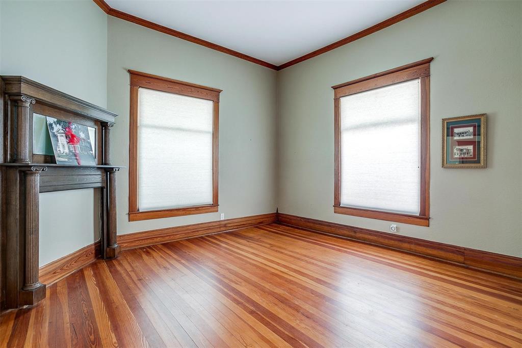 708 South Waco Street Weatherford, TX 76086 - Photo 27 of 35 an empty room with wooden floor and windows