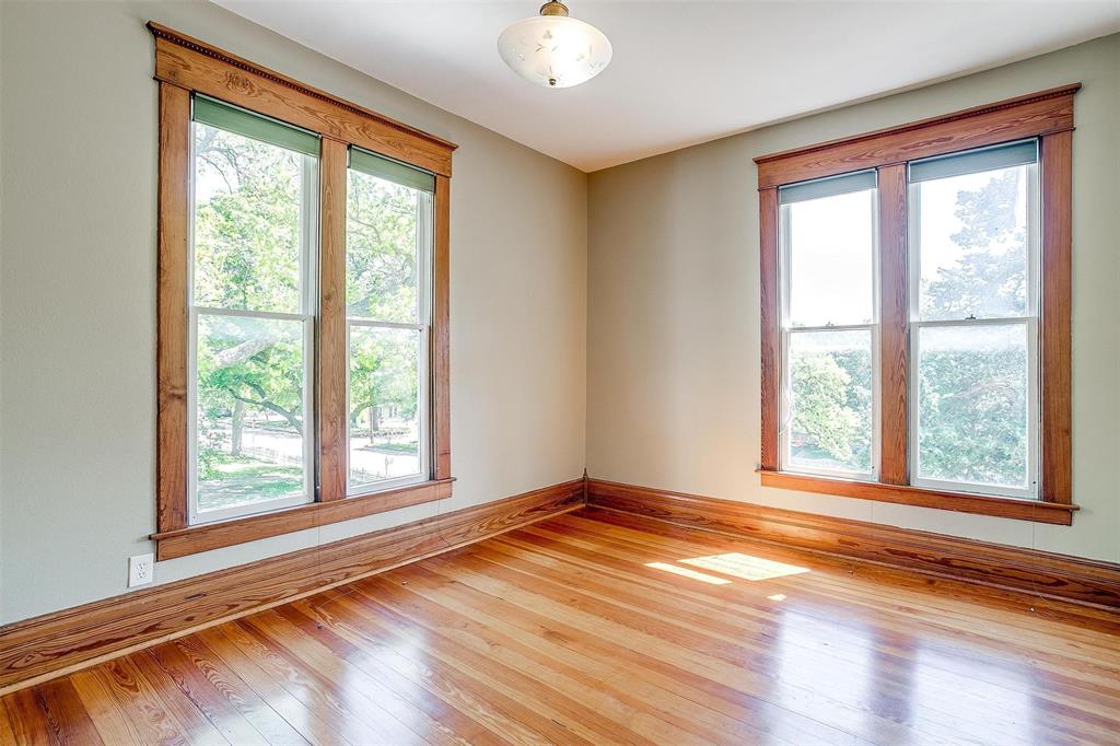 708 South Waco Street Weatherford, TX 76086 - Photo 6 of 35 a view of an empty room with wooden floor and a window
