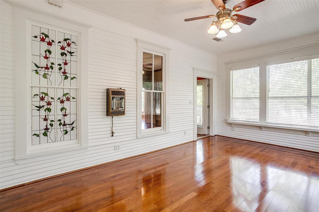 708 South Waco Street Weatherford, TX 76086 - Photo 9 of 35 a view of an empty room with a window and wooden floor