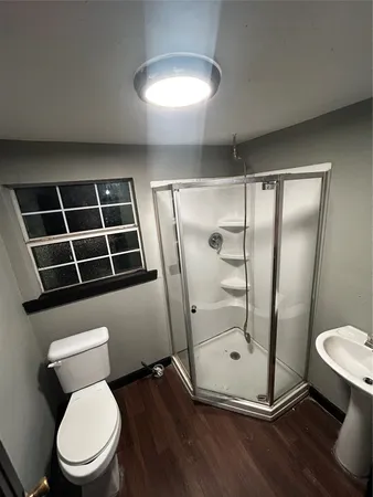 a bathroom with a toilet and a shower