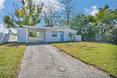 a view of backyard of house with large trees