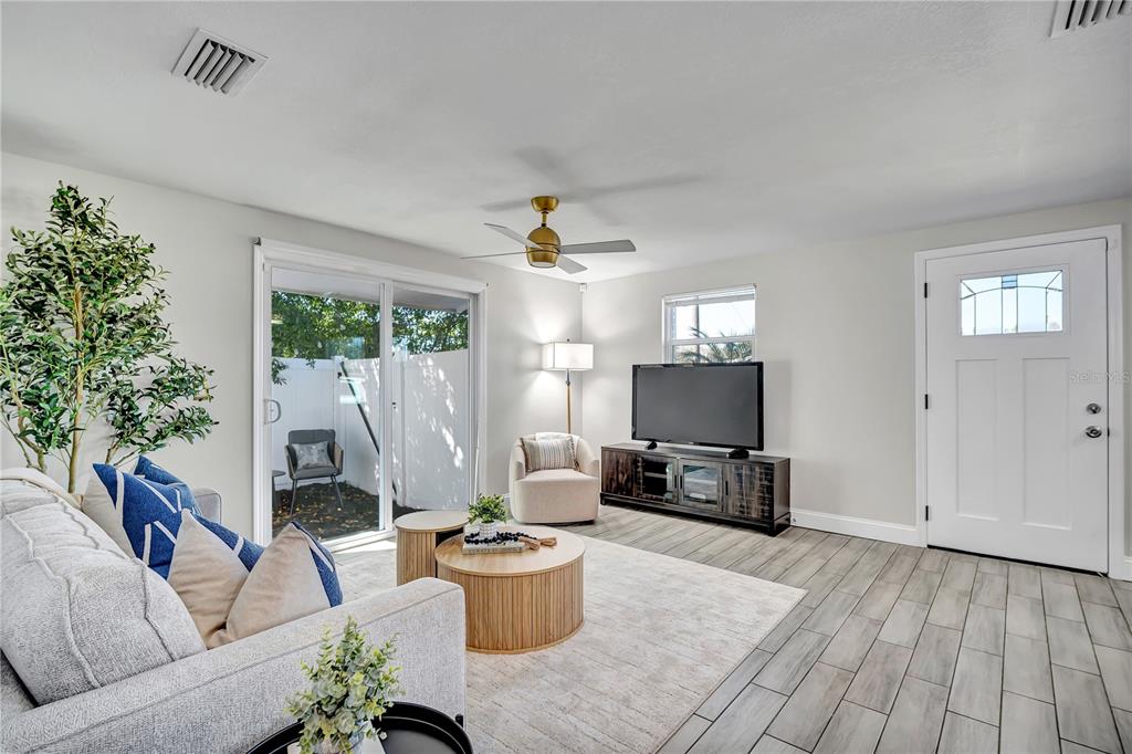 6510 West Chelsea Street Tampa, FL 33634 - Photo 8 of 20 a living room with furniture and a flat screen tv