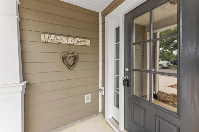 an empty room with wooden floor fireplace and windows
