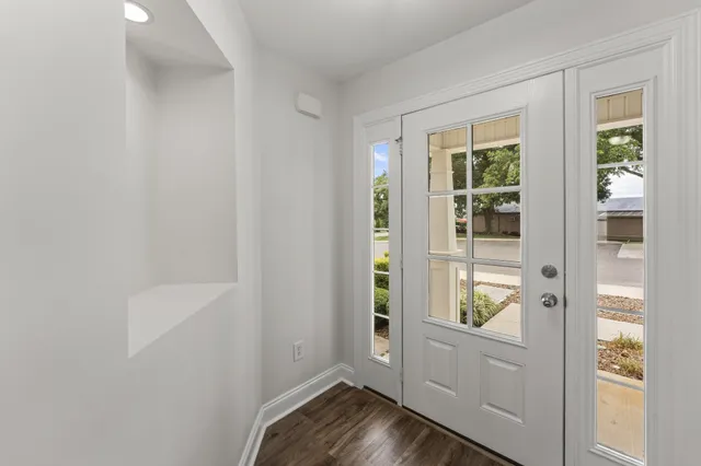 a view of a kitchen with wooden floor and a fireplace