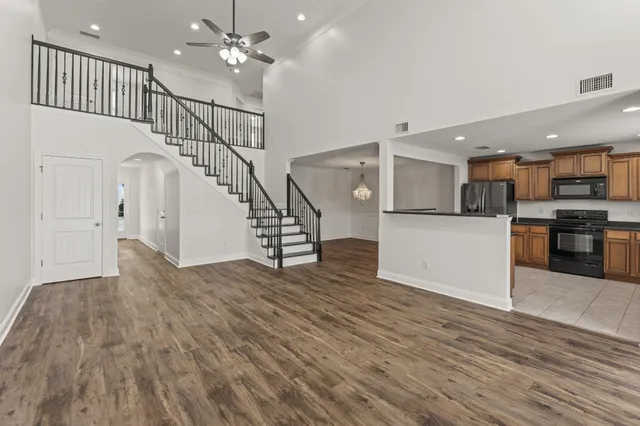 a kitchen with granite countertop a refrigerator stove and microwave