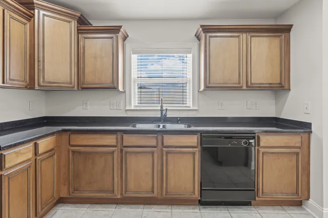 a view of a kitchen with cabinets and wooden floor
