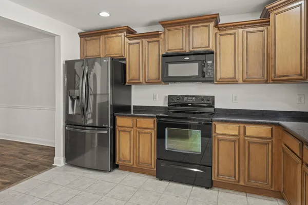 a kitchen with stainless steel appliances granite countertop a refrigerator sink and stove