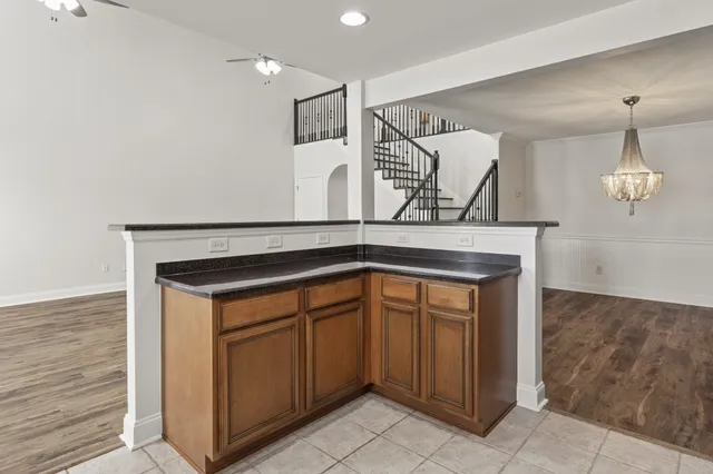 a view of a kitchen with wooden floor and a chandelier