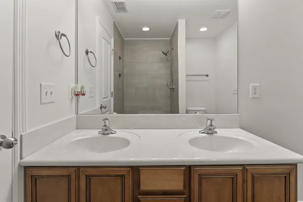 a bathroom with a granite countertop toilet and a shower