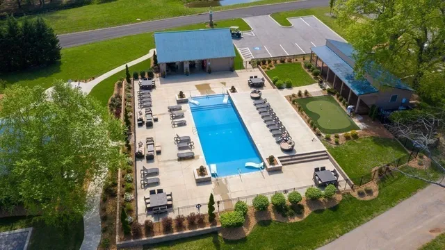 a view of a house with backyard sitting area and garden