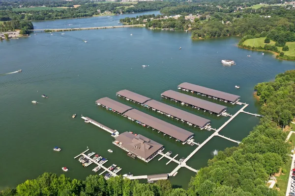 an aerial view of a house with a garden and lake view