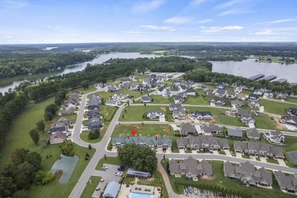 an aerial view of residential building and lake