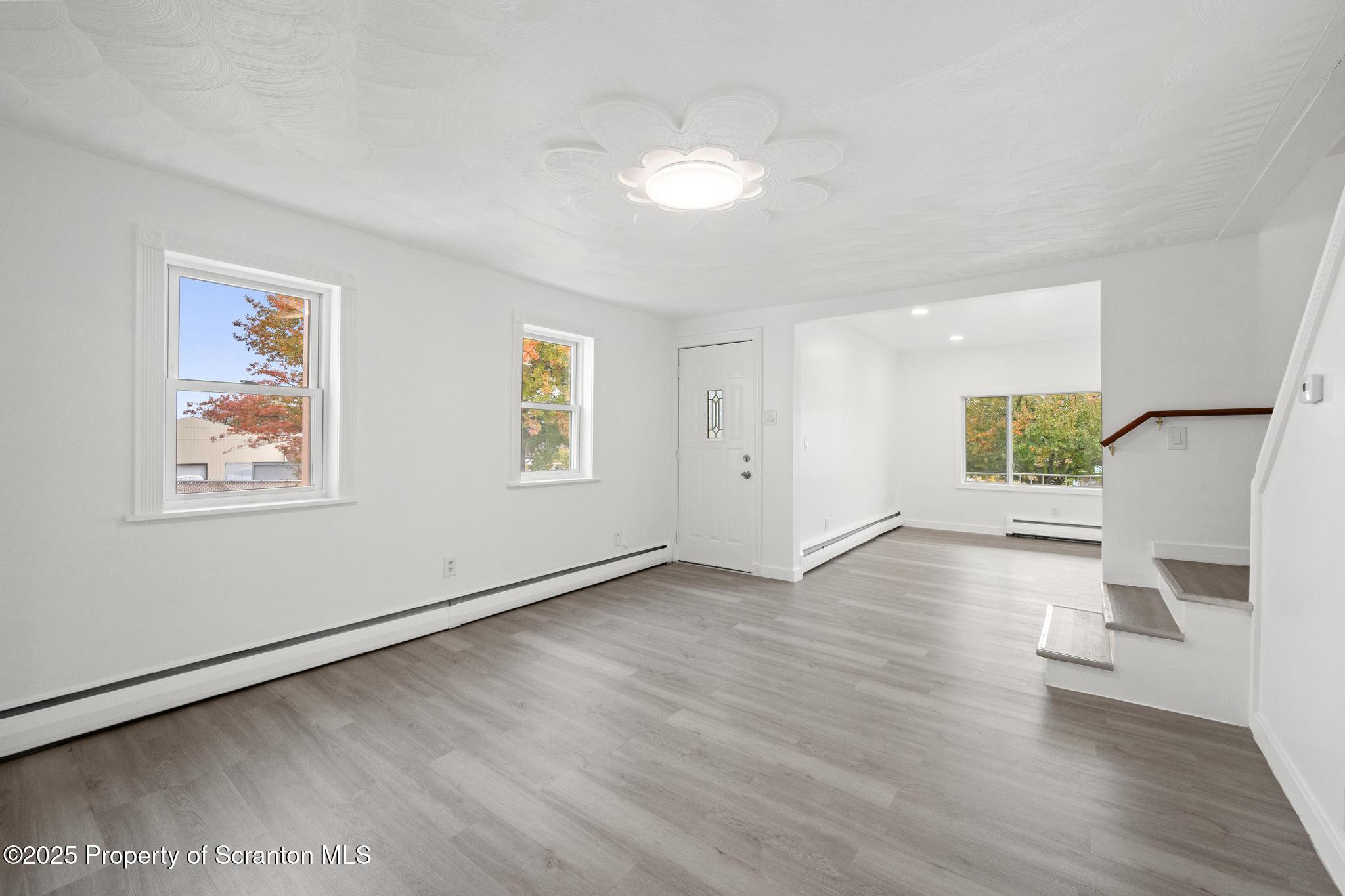 527 St Frances Cabrini Avenue, Unit 2 Scranton, PA 18504 - Photo 11 of 36 a view of a big room with wooden floor and windows