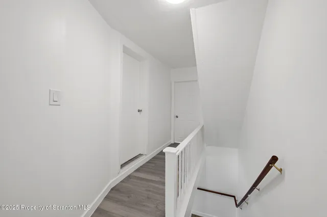 a view of a hallway with stairs