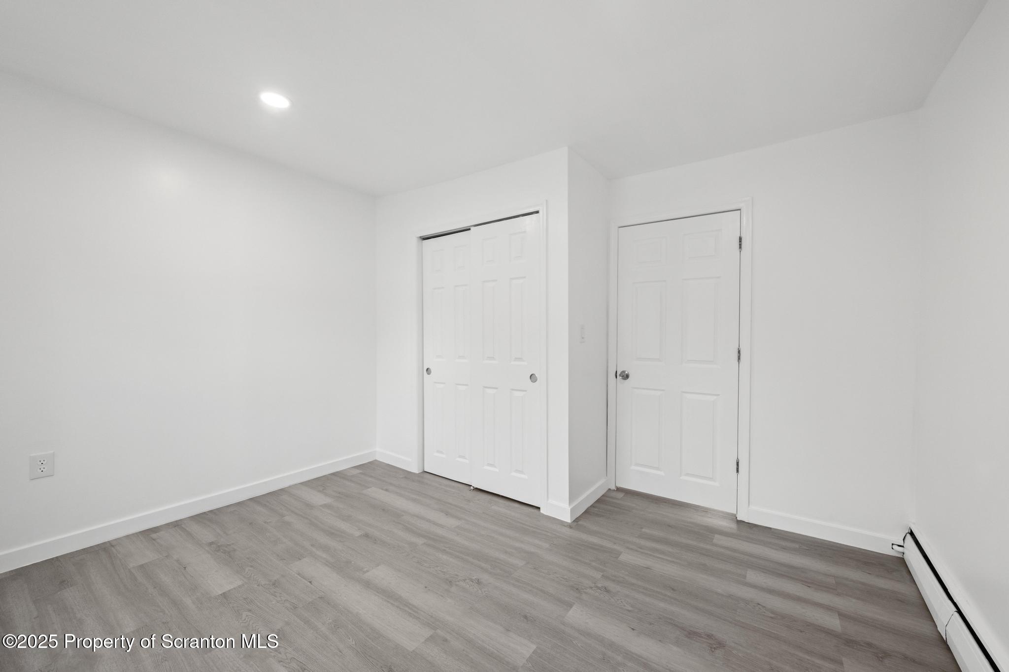 527 St Frances Cabrini Avenue, Unit 2 Scranton, PA 18504 - Photo 16 of 36 a view of an empty room with wooden floor