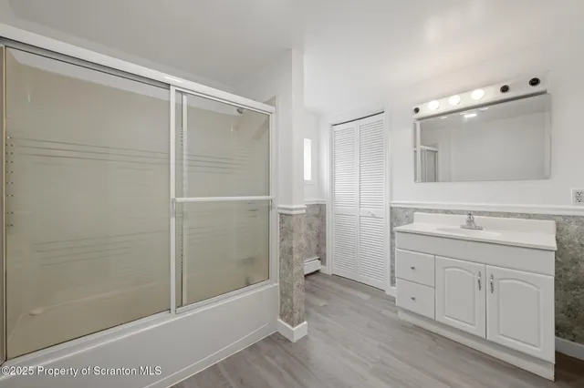 a bathroom with a shower and a sink