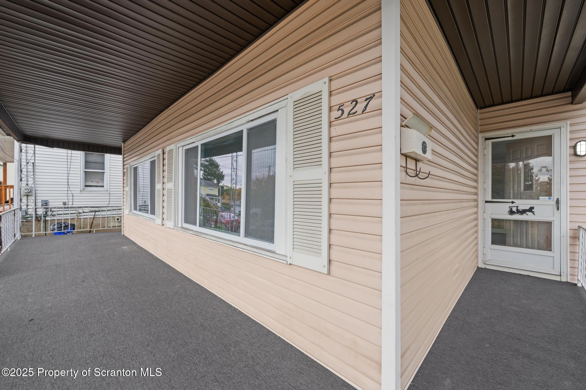 527 St Frances Cabrini Avenue, Unit 2 Scranton, PA 18504 - Photo 3 of 36 a view of a porch with a table and chairs