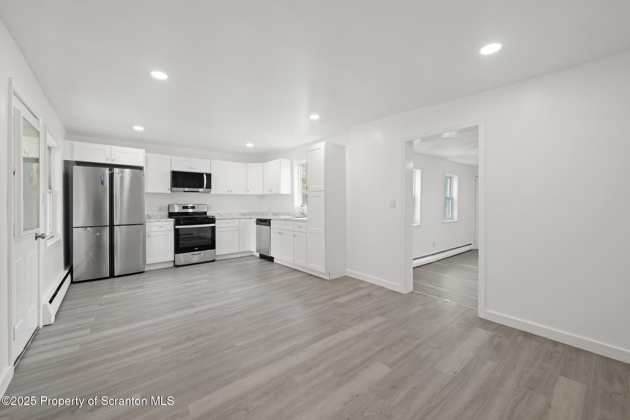 527 St Frances Cabrini Avenue, Unit 2 Scranton, PA 18504 - Photo 5 of 36 a view of kitchen with stainless steel appliances refrigerator microwave and stove