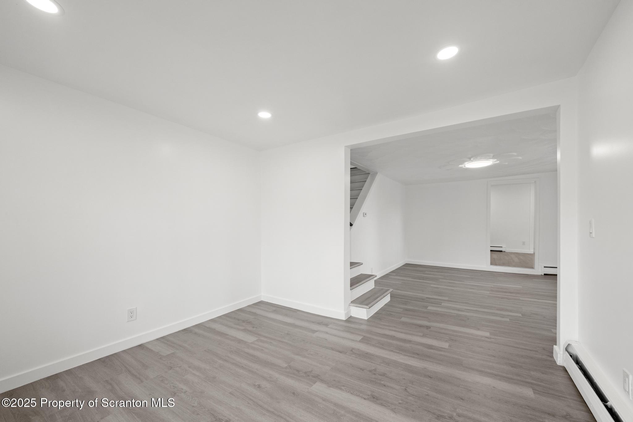 527 St Frances Cabrini Avenue, Unit 2 Scranton, PA 18504 - Photo 9 of 36 a view of an empty room with wooden floor and a window