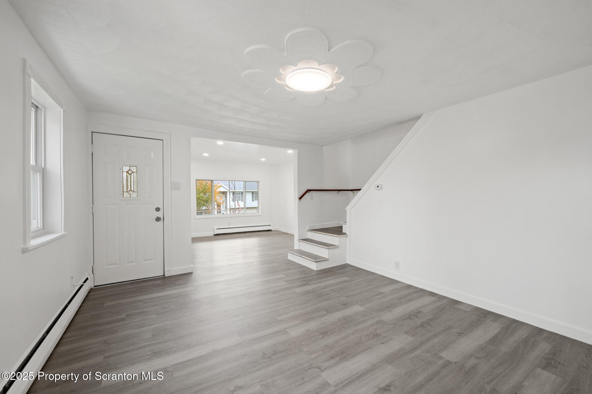 527 St Frances Cabrini Avenue, Unit 2 Scranton, PA 18504 - Photo 10 of 36 wooden floor in an empty room with a window