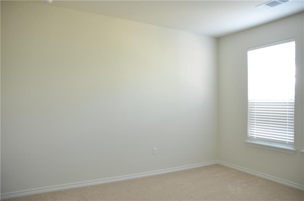 14403 McCoy Loop Austin, TX 78717 - Photo 22 of 29 An airy bedroom with soft carpeting and ample natural light through a large window.