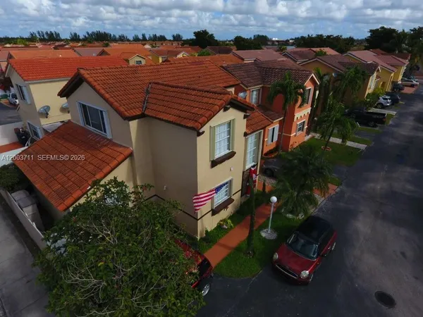 an aerial view of houses with yard