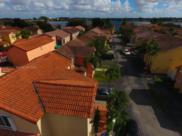 an aerial view of multiple houses with yard