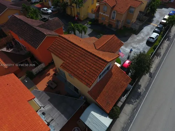 an aerial view of a residential apartment building with a yard