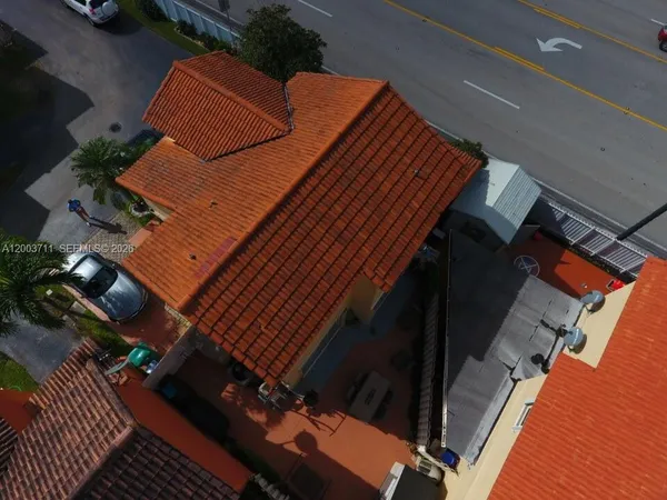 an aerial view of a house with a yard