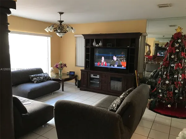 a view of a dinning table and chairs in back of a house