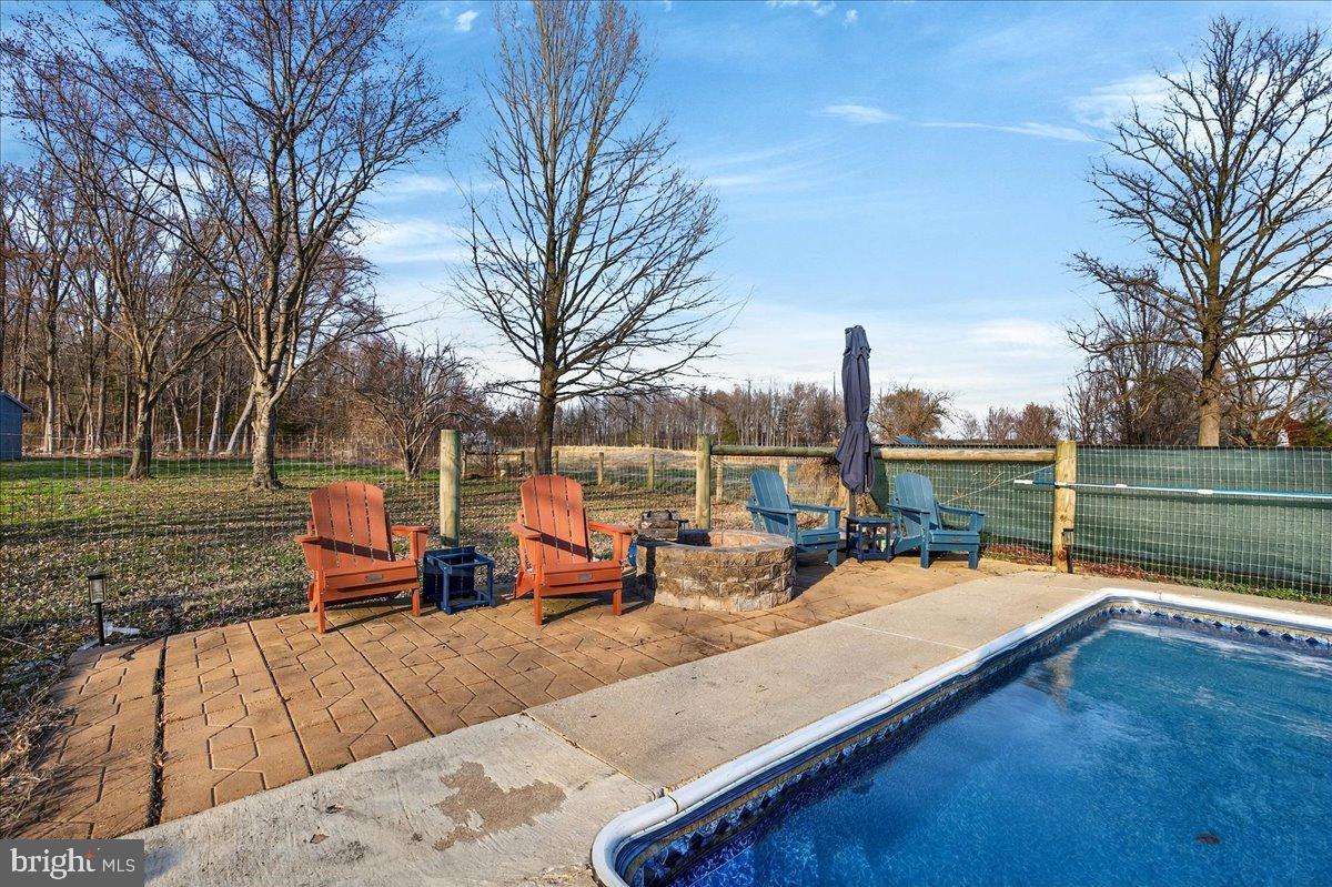 2505 West Denneys Road Dover, DE 19904 - Photo 54 of 68 Tranquil poolside retreat in nature's embrace.